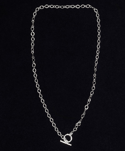 Silver-dipped oval link chain necklace with front toggle clasp on dark background.